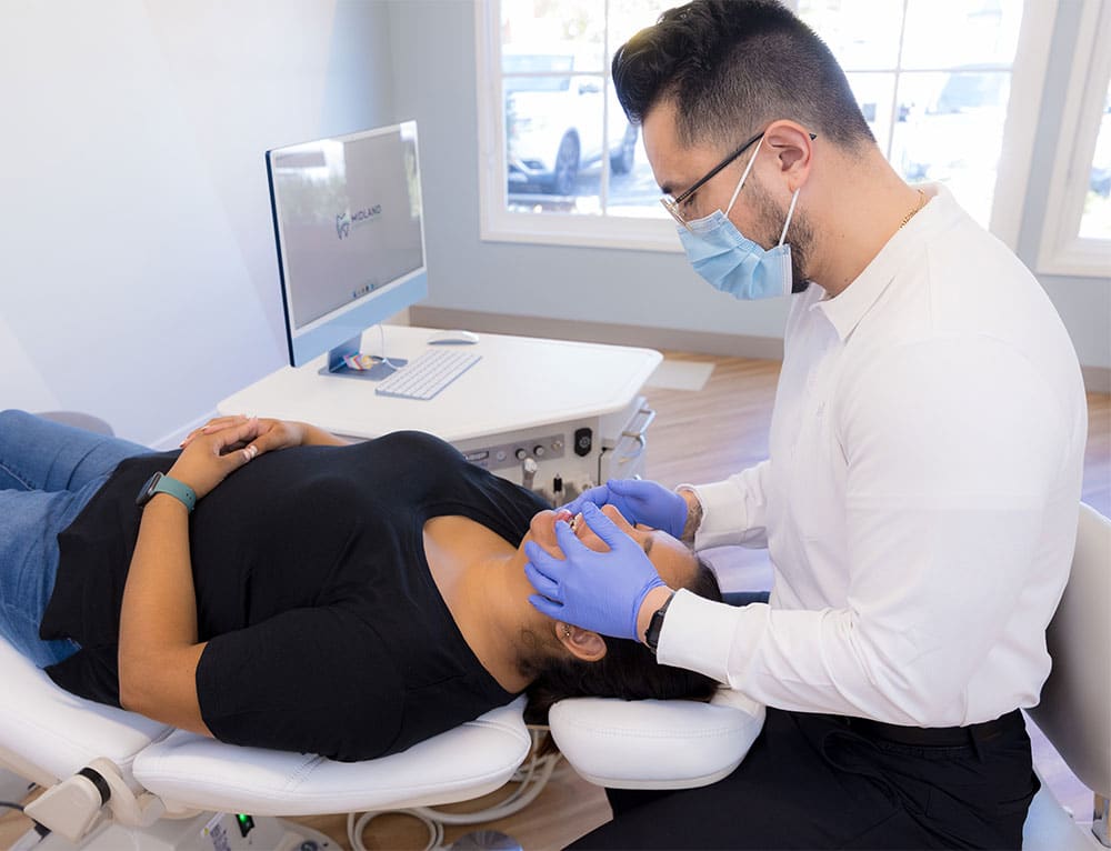 Dr. Yoo examining a patient's teeth