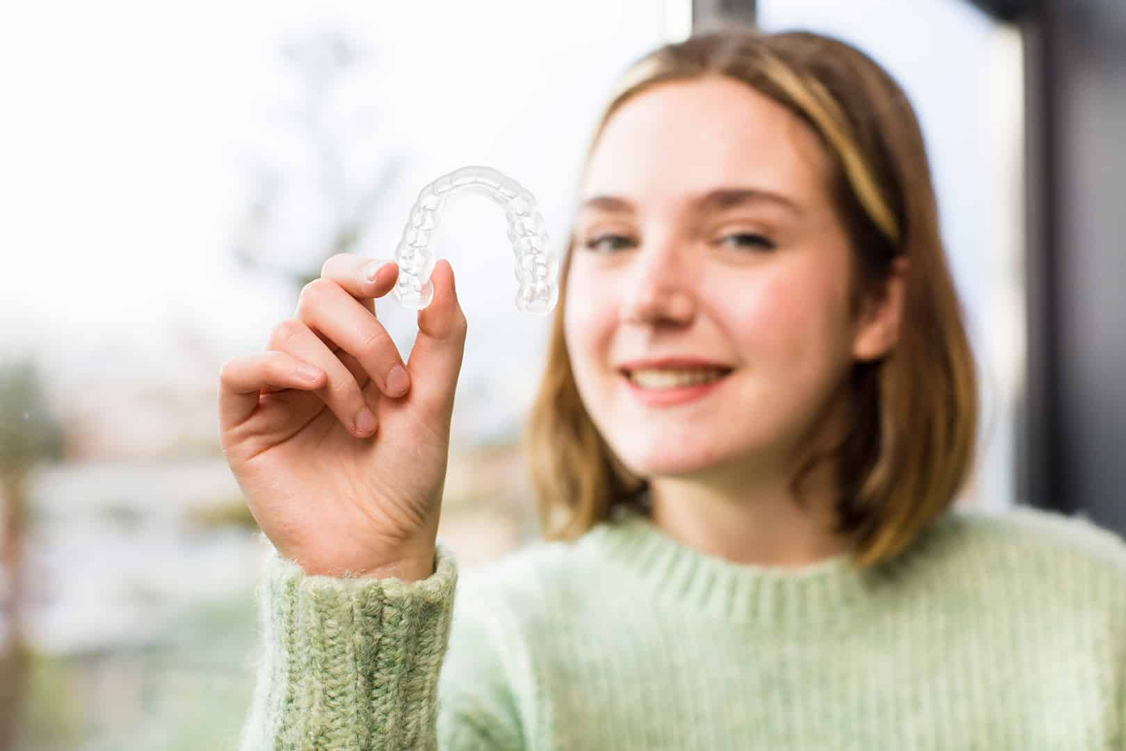 woman smiling with braces from midland orthodontic